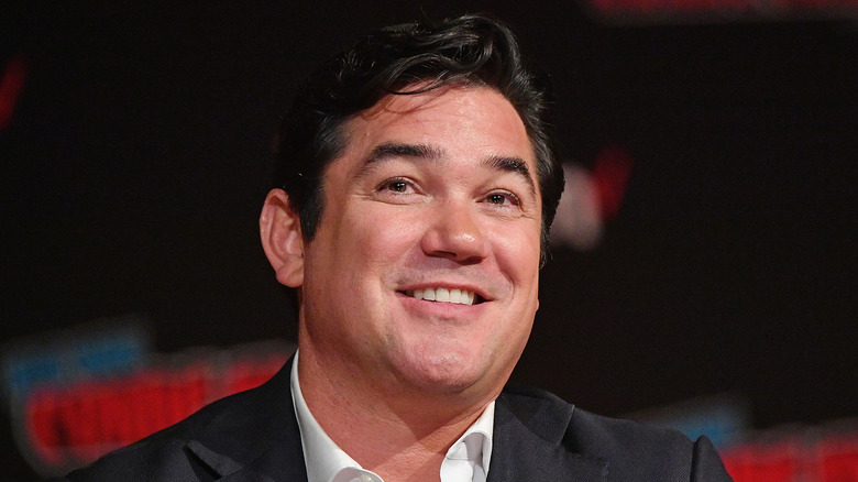 Dean Cain looks ahead smiling