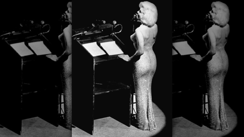 Marilyn Monroe sings Happy Birthday, Mr. President in her iconic dress.