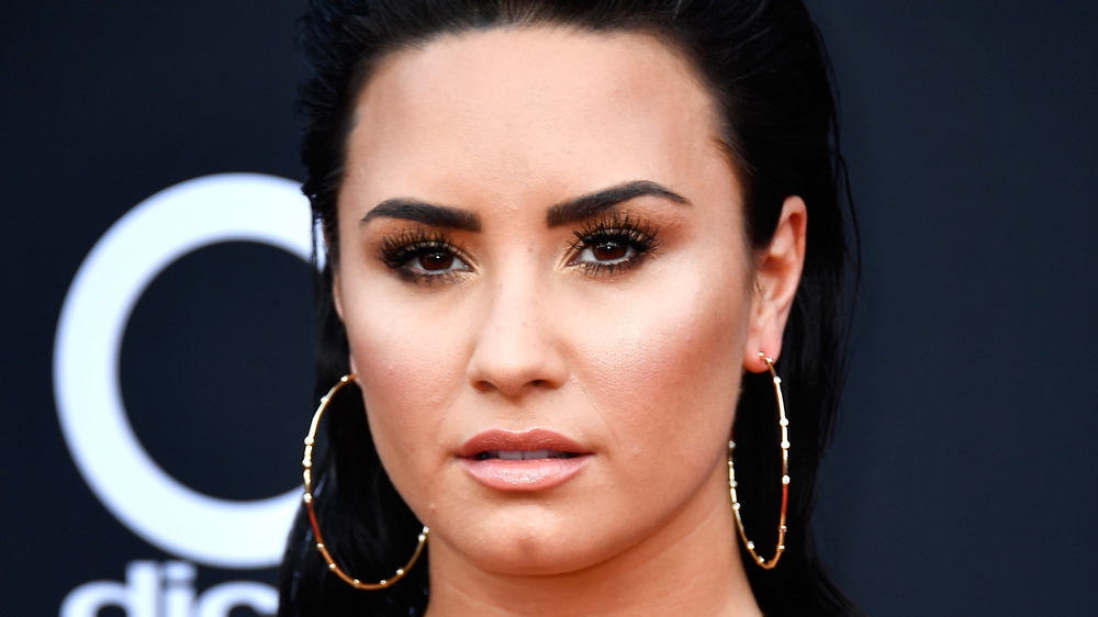 Demi Lovato with a serious expression