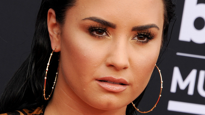 Demi Lovato with a serious expression