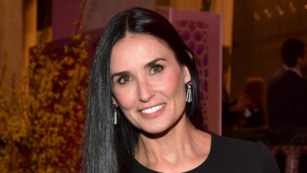 Demi Moore smiles at the camera at an event