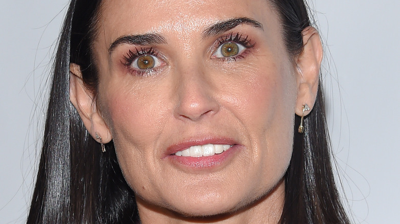Demi Moore smiles with straight hair