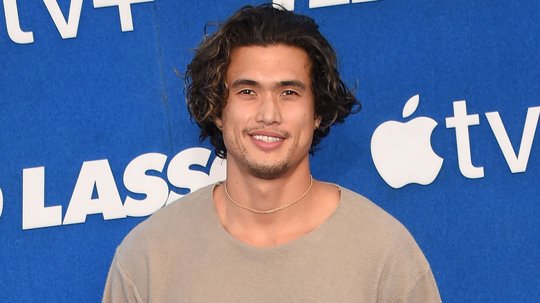 Charles Melton posing at an event