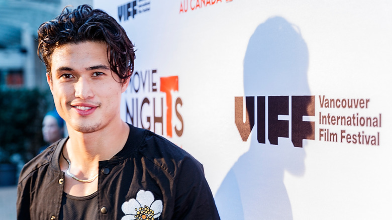 Charles Melton posing at an event