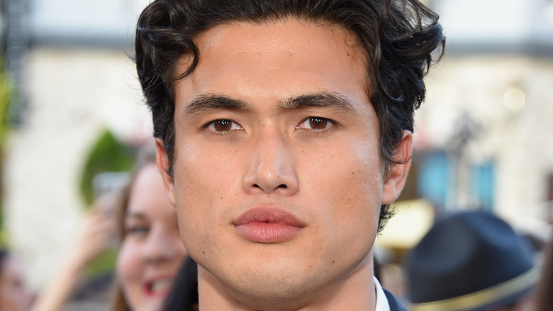 Charles Melton posing at an event