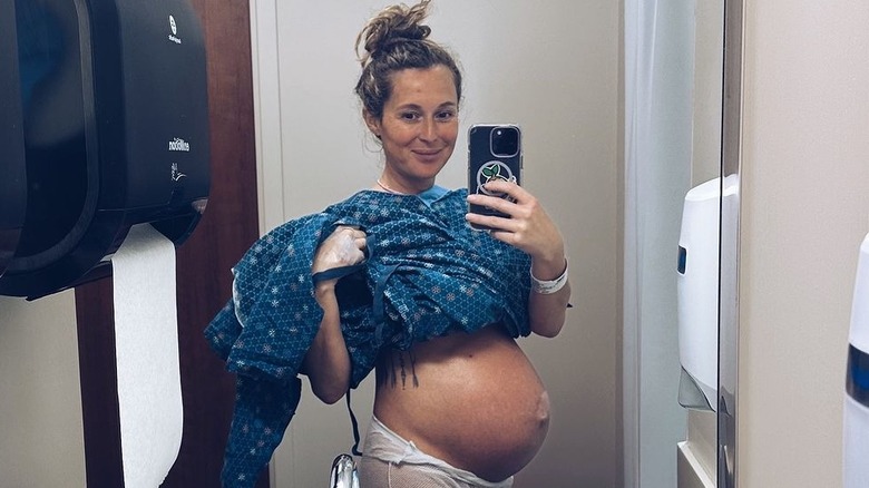 Alexa PenaVega taking selfie of baby bump