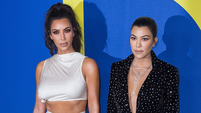 Kim and Kourtney Kardashian posing