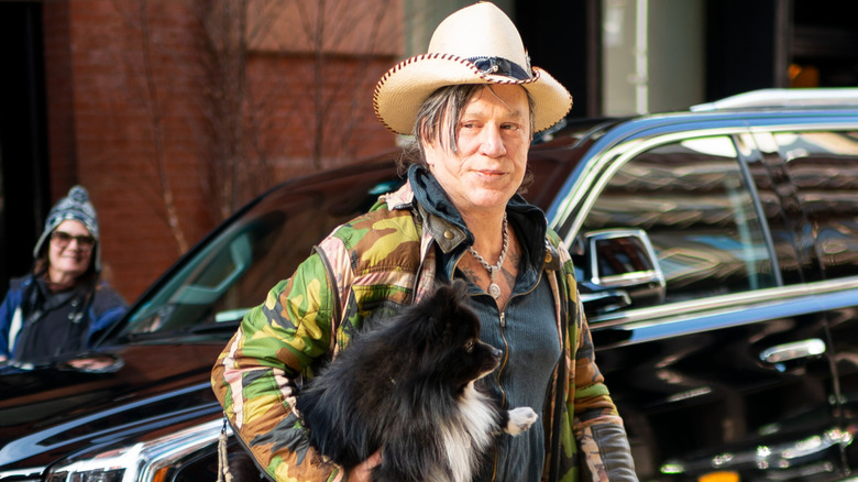 Mickey Rourke holding a dog