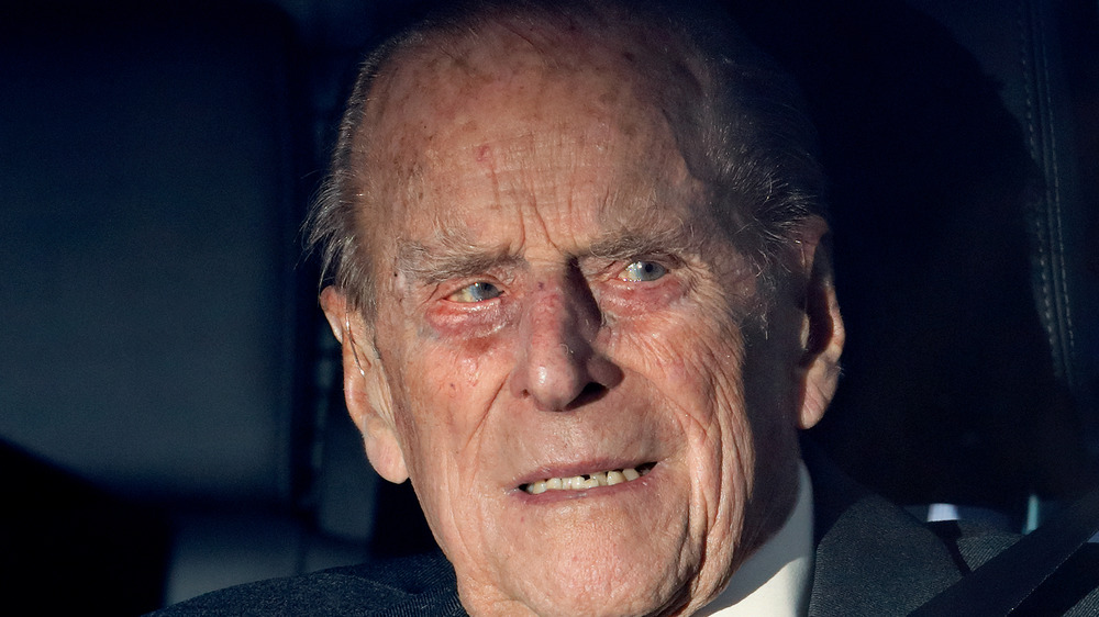 Prince Philip sitting in a car