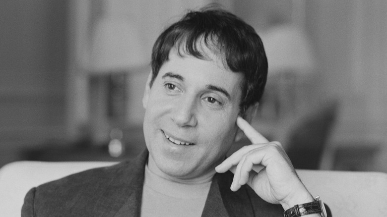 Paul Simon smiling on couch