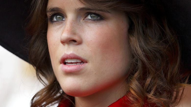 Princess Eugenie smiling in a car
