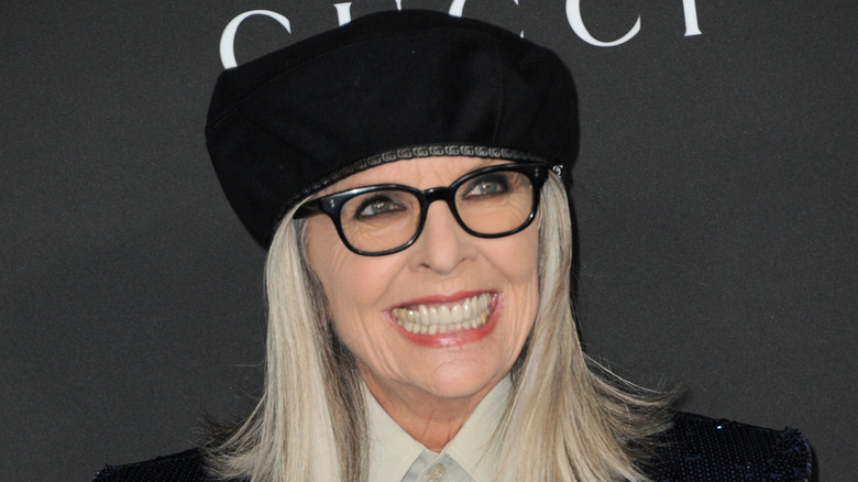 Diane Keatonn smiling in a black beret