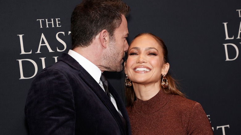 Ben Affleck whispering to Jennifer Lopez