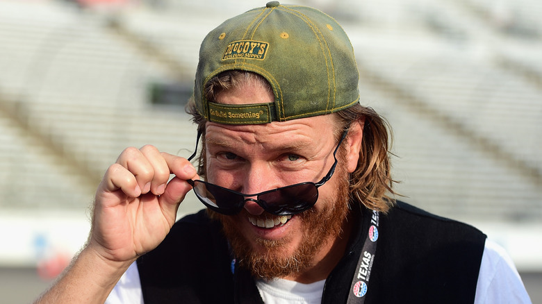 Chip Gaines posing at a NASCAR race.