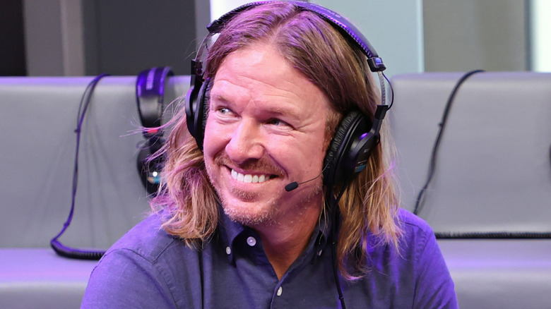 Chip Gaines smiles on a radio show wearing a headset