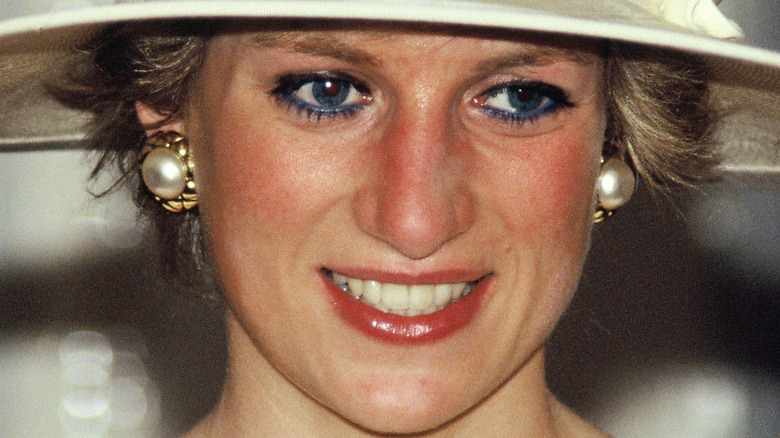 Princess Diana wearing a hat and smiling