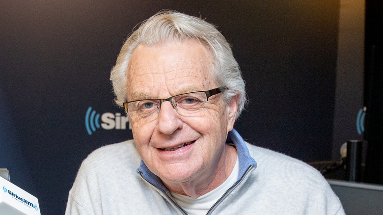 Jerry Springer sits in a studio