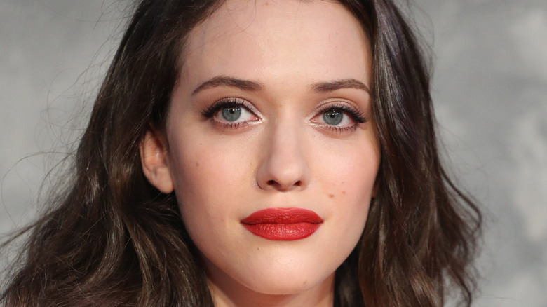 Kat Dennings with bright red lip and mussy hair