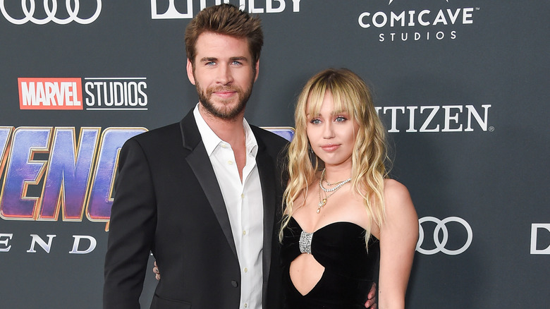 Miley Cyrus and Liam Hemsworth posing