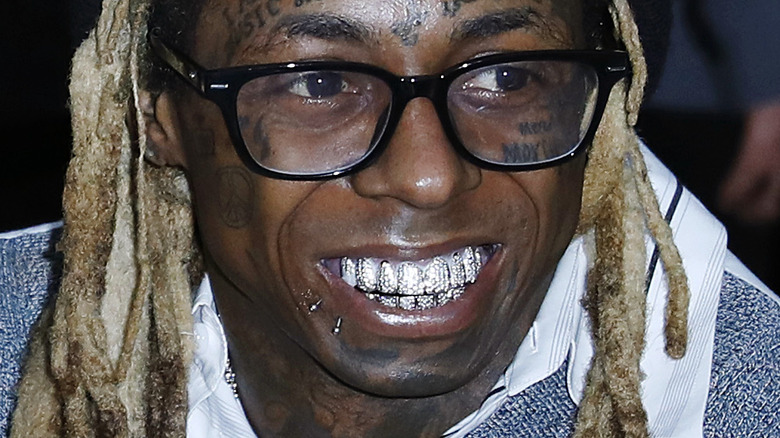 Lil Wayne smiling and wearing glasses