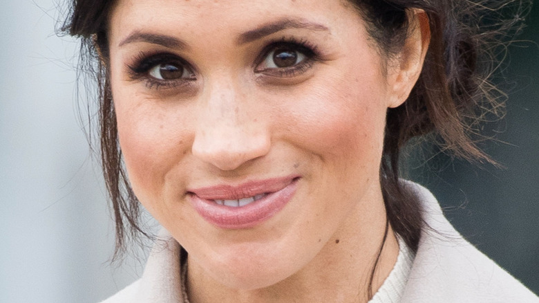 Meghan Markle slightly smiling