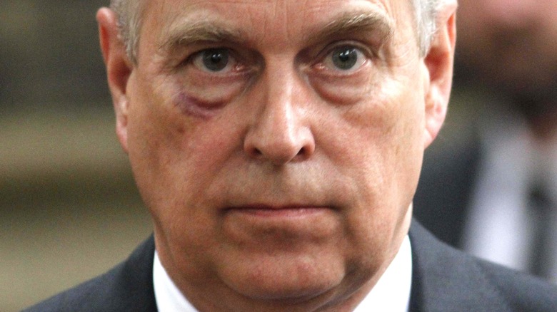 Prince Andrew grimaces at a public event