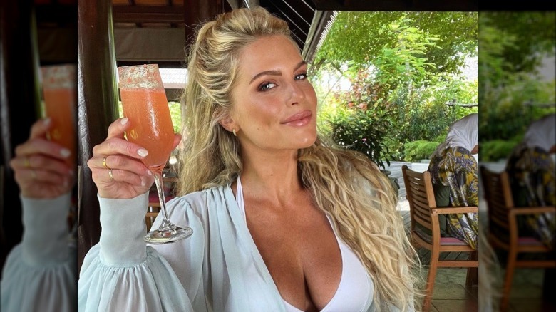 Madison LeCroy raising a mimosa in a toast