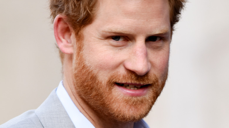 Prince Harry looks sheepish at an event