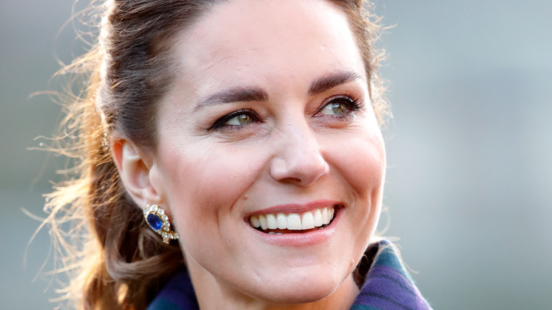 Kate Middleton and Prince William looking at a baby