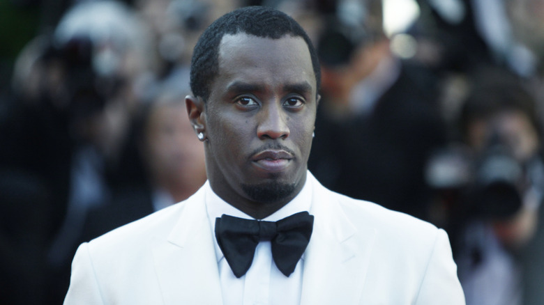 Sean 'Diddy' Combs posing at the premiere of "Killing Them Softly" while wearing a white suit and black bowtie.