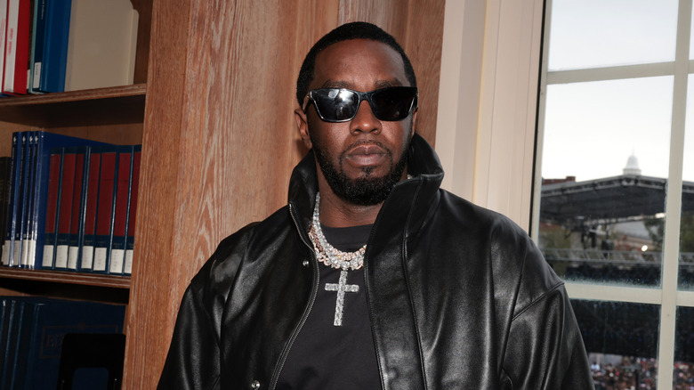 Diddy standing in front of a window