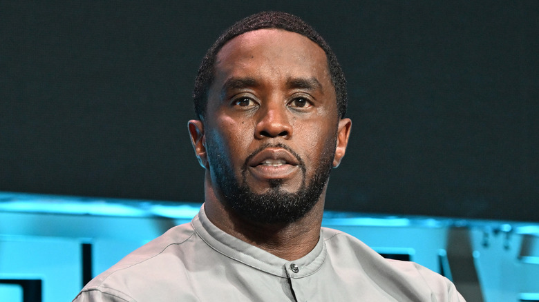 Sean 'Diddy' Combs with a black goatee staring into the camera