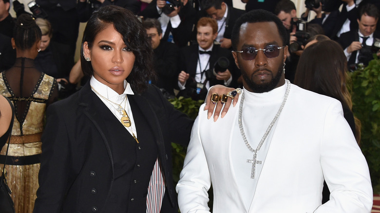 Cassie with hand on Diddy's shoulder
