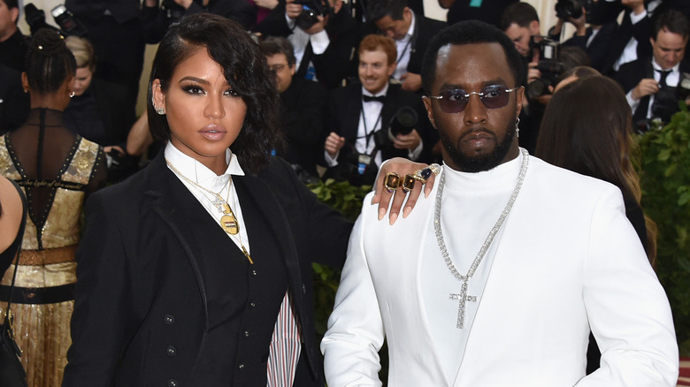 Cassie with hand on Diddy's shoulder