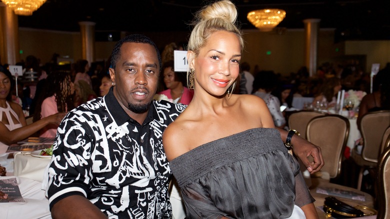 Diddy with his arm around Sarah Chapman