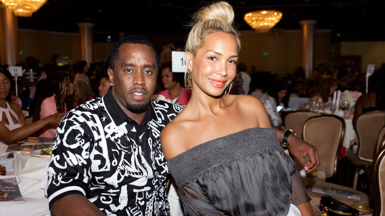 Diddy with his arm around Sarah Chapman