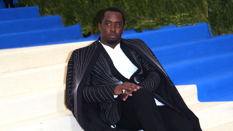 Sean Combs lying on stairs