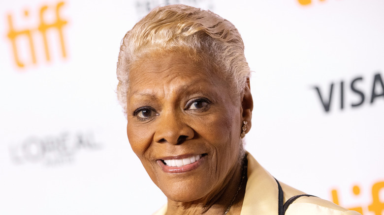 Dionne Warwick poses in a tan suit
