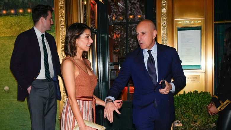 Matt Lauer reaches for Shamin Abas' hand at Don Lemon's wedding.