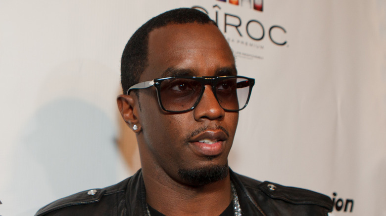 Diddy wearing sunglasses and a black jacket while at the Grammys afterparty.