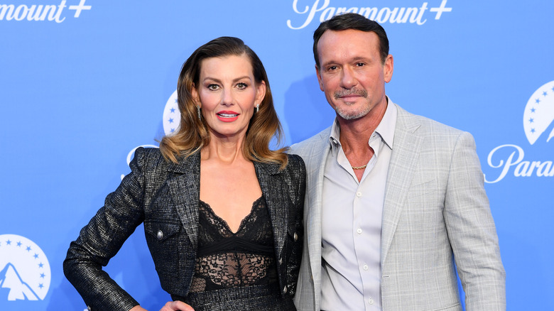 Faith Hill and Tim McGraw pose for photos at an event