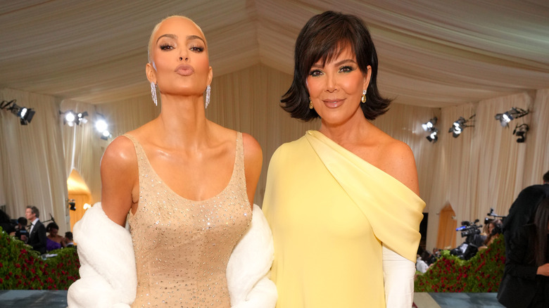 Kim Kardashian puckering next to Kris Jenner