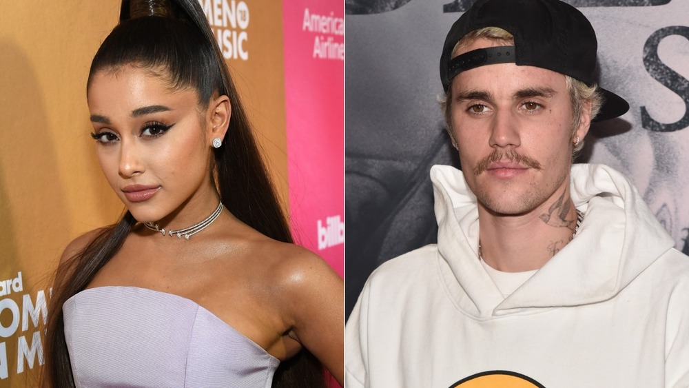 Justin Bieber and Ariana Grande pose on a red carpet 