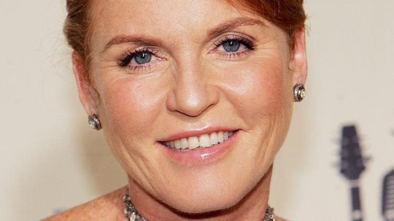 Sarah Ferguson smiles with earrings and a necklace.