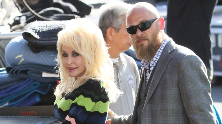 Dolly Parton being escorted by her nephew and head of security Bryan Seaver.