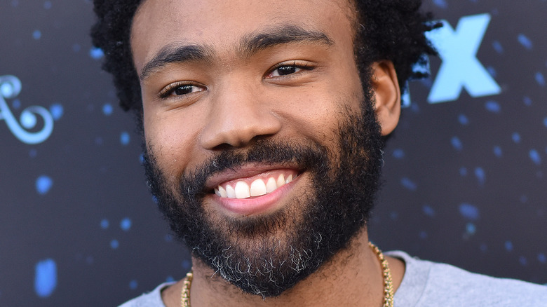 Donald Glover smiling white teeth thick beard