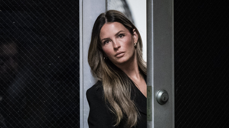 Margo Martin looking through door