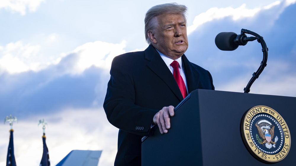 Donald Trump speaking in front of a podium