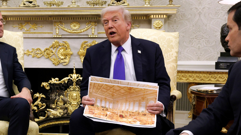 President Donald Trump displaying a rendering of his proposed $250 million White House ballroom as he meets with NATO Secretary General Mark Rutte (L) in the Oval Office of the White House