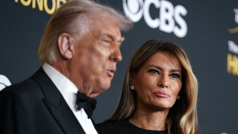 Donald Trump speaking with Melania Trump